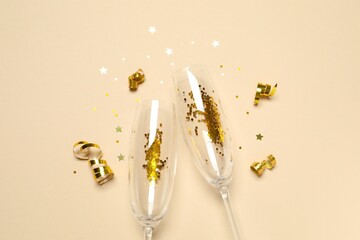 Festive background with champagne glasses and confetti