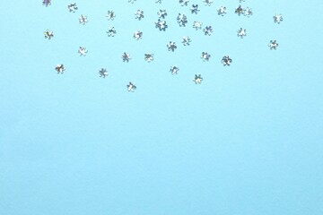 Beautiful silver confetti on a color background