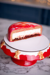 Cutting a festive mousse cake decorated for winter celebrations during the holiday season with a beautiful red and white design