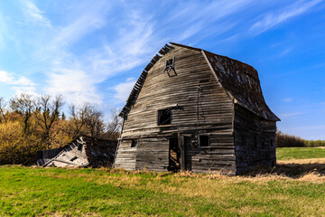 A large, old barn with a lot of wood on it