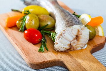 Hake baked by rustically style. Hake 250 gramm (it is better to take the tail), rub it with salt and pepper, bake in the oven for 20 minutes at 220 gramm Served with potatoes and fresh vegetables