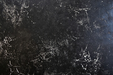 Black grunge texture with abstract white scratches and cracks background