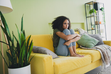 Full size photo of pretty young girl sit couch bad mood weekend pastime apartment indoors