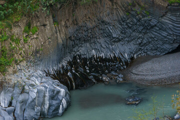 Detail of Gole dell Alcantara gorge formed by basalt columns with river near to Etna volcano, Motta...