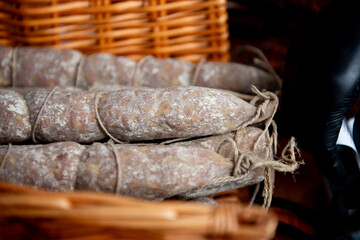 traditional spanish salami or dry sausage covered ,fermented mold in a basket.