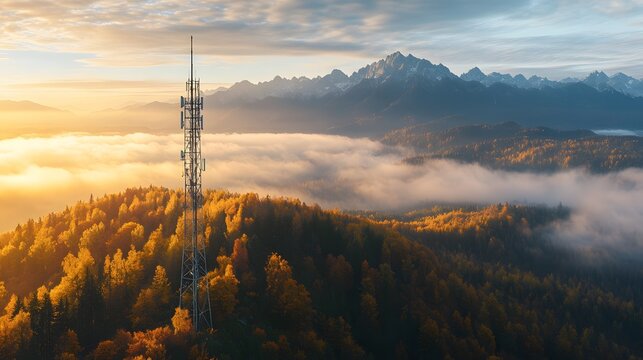 Sunrise over autumnal mountain range with telecommunications tower.