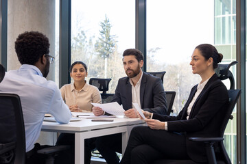 Job interview scene with diverse business team and candidate engaging professionally in modern...