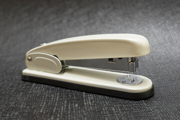 Close-Up of a Black and White Stapler: A Blend of Functionality and Minimalist Design Highlighted...