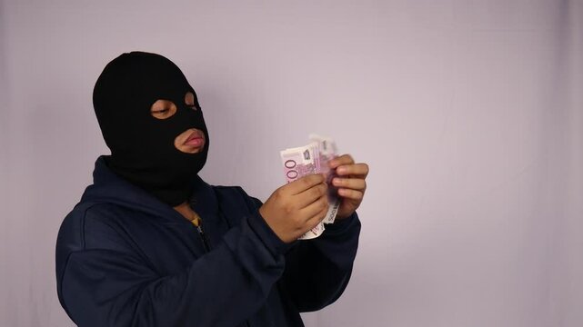 close up on the thief wearing jacket counting bundles of 500 euro banknotes with white background.
