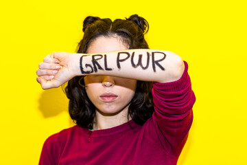 woman showing grl pwr message on arm