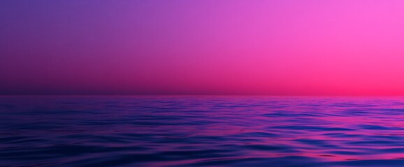 Obraz premium Purple and pink sunset over calm ocean water.