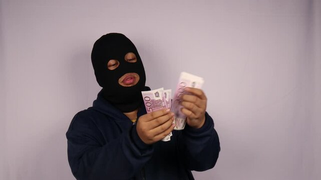 close up on the thief wearing jacket counting bundles of 500 euro banknotes with white background
