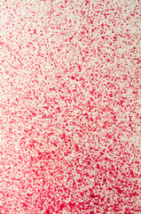 Red liquid splashes create abstract patterns on a light surface