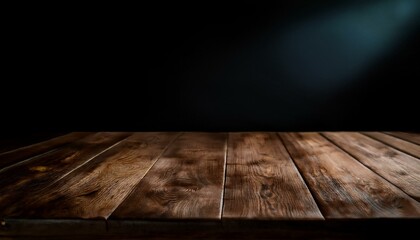 A rustic wooden table in sharp focus, with a blurred dark black background