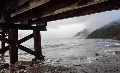 Wooden bridge jetty pier in the water west coast new zealand
