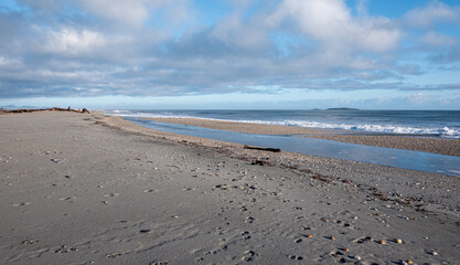 Picturesque beach with small waves sea foam new zealand west coast