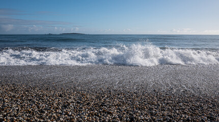 Picturesque beach with small waves sea foam new zealand west coast