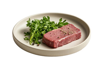 Fototapeta premium Fresh cut beef steak on a plate with garnish of parsley, ready for preparation in a modern kitchen setting