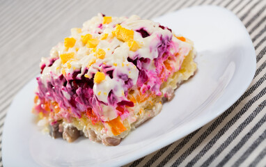 Photography of plate with Dressed herring is russian traditional dish in restaurante.