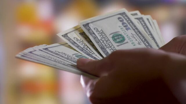 Hands hold and count cash money in hands. Passive income concept