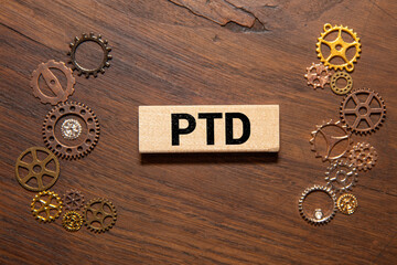 PTD acronym concept. Text on wooden cubes with bright light.