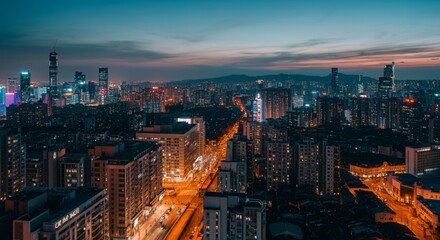 Obraz premium Aerial view of a cityscape with lights glowing at twilight