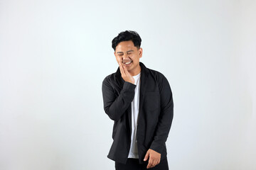 Young Asian Man Standing Over White Background Touching Mouth with His Hand