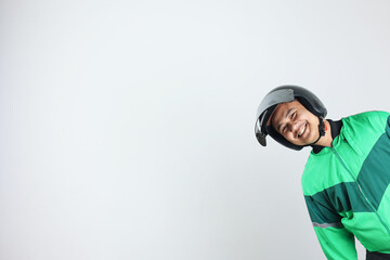 Online Taxi Driver Gojek Motorbike Man Smiling from The Side of White Wall Background
