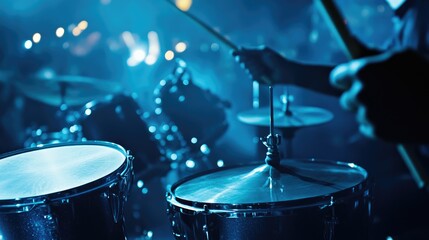 Naklejka premium Dynamic Drummer Performing in Vibrant Blue Stage Lighting