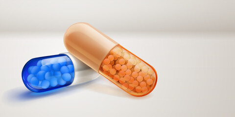 Translucent blue and orange capsules with soft shadows, filled with smal medicine granules inside, lying on a white surface