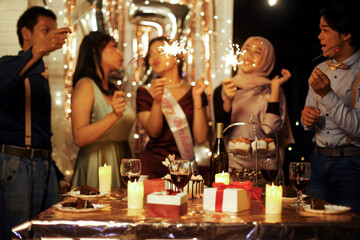 Group of Multiethnic Asian Friends Having Fun Celebrating Birthday Girl With Sparklers