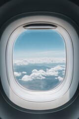 Naklejka premium A stunning aerial view of mountain ranges seen through an airplane window, with soft clouds drifting by.