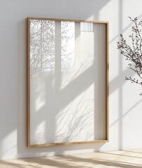 Minimalist Framed Art Piece on White Wall with Sunlight and Shadows