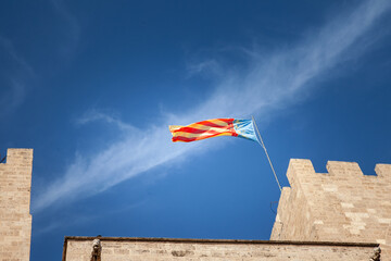The flag of Comunidad Valenciana (valencian community) waves in Valencia, Spain, symbolizing...