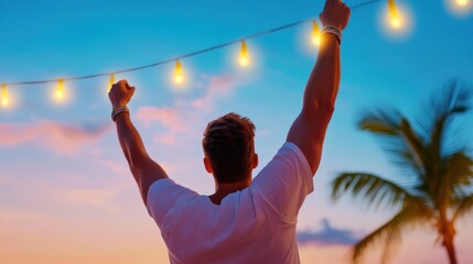 A man is standing in the ocean with a palm tree in the background