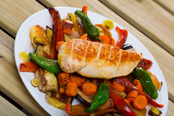 Dish of Bulgarian cuisine plakia, tasty chicken fillet and different baked vegetables