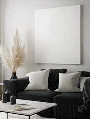 A modern living room with a black sofa. white pillows. a white coffee table. and a large blank canvas on the wall