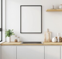 A blank framed picture hangs above a kitchen countertop with white cabinets and a wood counter