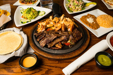 Seafood and steak fajitas in a skillet