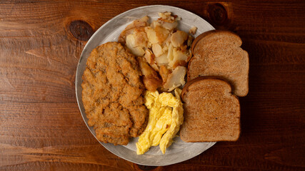 Country fried steak, eggs and potatoes