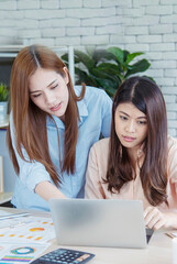Vertical Horizon Happiness two women working together confident team meeting office desk. Vertical startup Team business partners working laptop. Asian colleague friendship at work with smiling face
