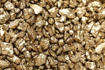 Shiny gold nuggets as background, top view