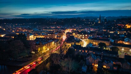Charming town at dusk with vibrant streetlights.