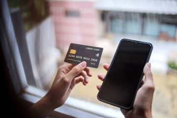 Portrait of Hand Holding Credit Card and Smartphone Shopping Online Using Internet at Home