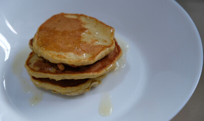 Homemade gluten free pancake made from mocaf flour on a white plate.