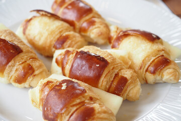 Savor our Delicious Mini Croissants, freshly baked with a golden glaze for exquisite flavor