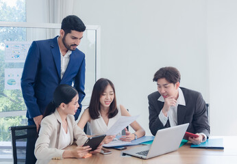 Business team woman and man asian group meeting sitting on desk looking talk think creative idea computer on table ready happy working new project job online product sale marketing in office company.