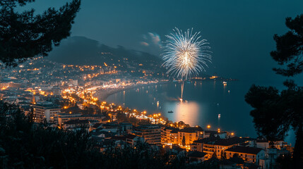Fireworks illuminate coastal city at night during summer celebration
