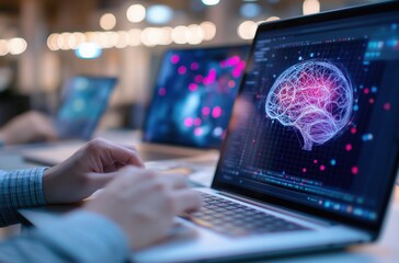 A person uses a laptop displaying a digital brain graphic, indicating themes of technology, data, and neuroscience in a modern workspace.