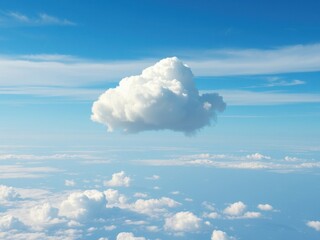 Soft white cloud floats above a brilliant blue sky with not a single contrail in sight , airy, outdoors
